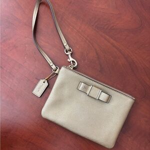 COACH Metallic Gold Bow Coated Canvas Wristlet